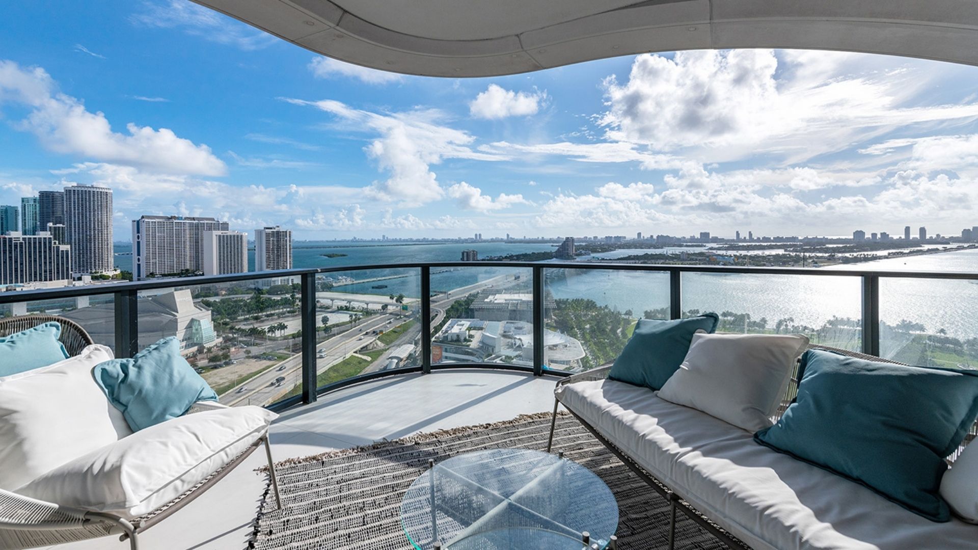 large outdoor terrace with wooden flooring, a private pool, and hanging gardens outside one of the residences at Monad Terrace